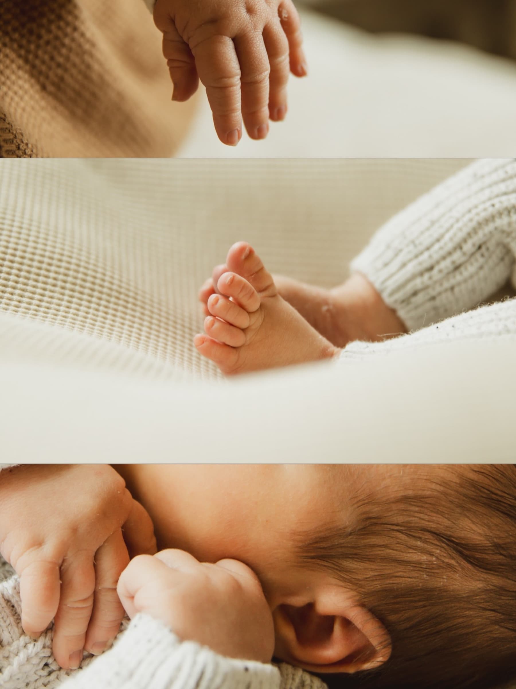A small child curls their fingers around an adult hand.